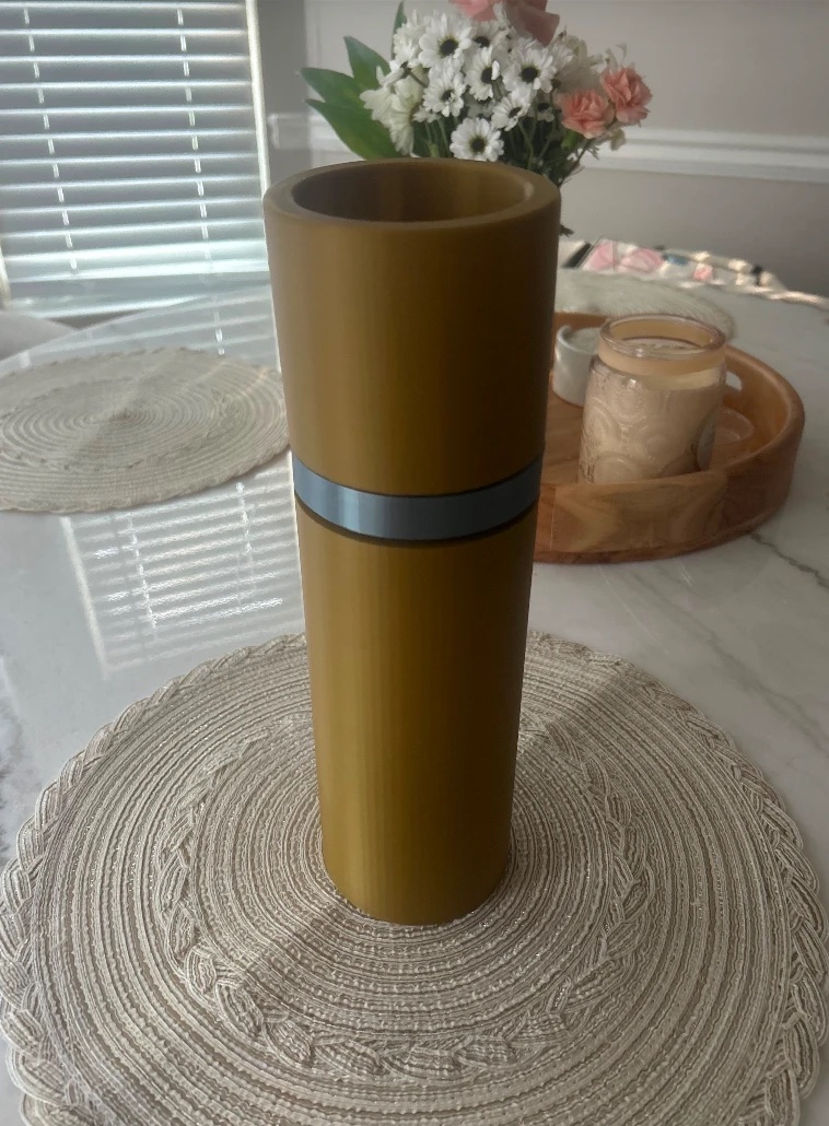 3D printed prototype of the Capí bottle in gold with a grey band